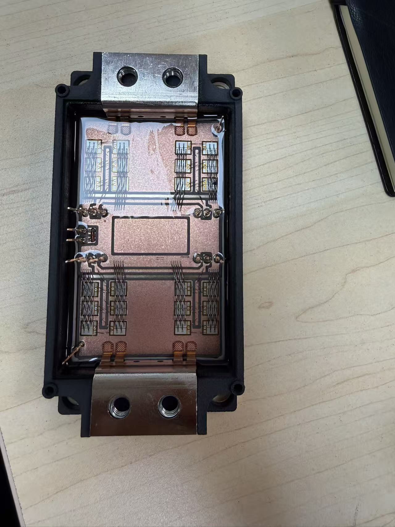 Open ProTac power-module prototype showing bonded semiconductor dies and copper power terminals